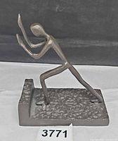 Front angled view showing full abstract figure and vertical wall support