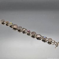 Full view of charm link bracelet laid flat
