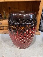 Full view of ceramic garden stool showing glazing and perforations