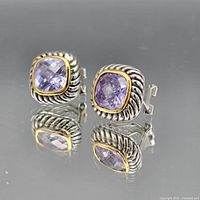 Front view of both cushion earrings showing silver rope framing, gold bezel and purple stones