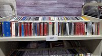 Full shelf showing entire row of CD spines