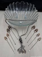 Overall lot view showing glass bowl, eight shell picks and braided shell necklace