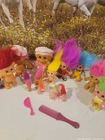 Group of troll dolls, mini ring trolls and combs on tabletop