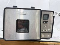 Front and top view of stainless steel Cuisinart bread maker showing lid with window and overall wear