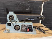 Full left side view showing belt drive, chain drive, dust port, power cord and overall wear