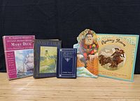 Group shot of all five books standing upright on table