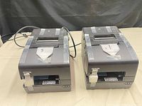 Front view of both Epson printers side by side on table