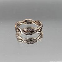 Front view of intertwined eternity ring showing cubic zirconia setting