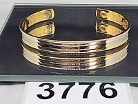 Full view of cuff on mirror showing exterior design and magnetic ends