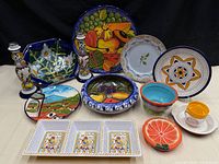 Entire lot showing all thirteen majolica-style ceramic pieces