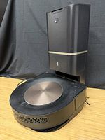 Roomba vacuum seated on Clean Base dock