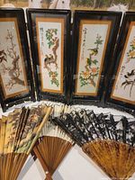 Overall view of four embroidered panels and five fans