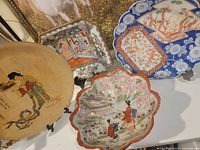 Group view of four decorative plates/bowl