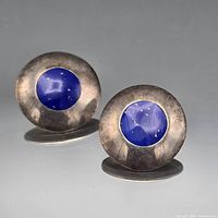 Front view showing both cufflinks with blue lapis centers and silver-tone discs