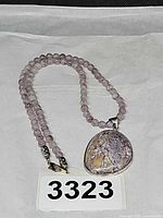 Full view of beaded amethyst necklace with jasper pendant on white background
