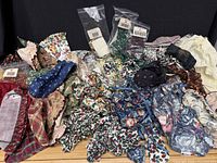 Pile of assorted Longaberger fabric liners and garters laid out showing variety