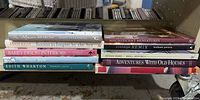 Spines of 10 hardcover interior design books on shelf cart