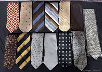 All 13 neckties laid out in two rows showing full patterns and colours