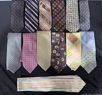 Full lot showing 13 assorted ties laid out