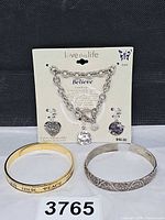 Overall lot: charm bracelet set on card plus two bangles
