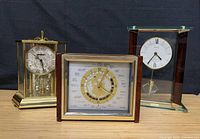 Three clocks grouped together showing overall designs and materials