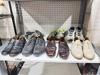 Shelf view of all eight pairs men’s shoes