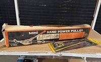Power puller box and Stanley cane bolt on table