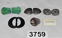 All six buckles and clips arranged on neutral background