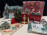 All items grouped: packaged rugs/throws, stocking holders, centerpiece, placemats, napkins
