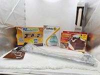 Full lot showing five packaged items and towel bar hardware