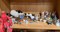 Shelf view showing majority of figurines and plush