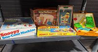 Overview of five boxed vintage toys and games on shelf
