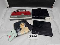 Group shot of all four wallets and coin purse