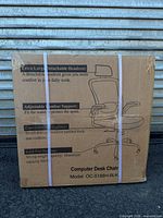 Front of sealed carton showing chair illustration and features