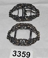 Pair of matching ornate brass buckles