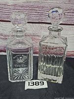 Front view of both decanters showing overall form, vertical cuts, and etched Sunny King logo