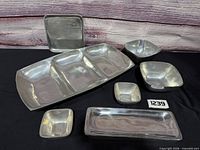 All seven aluminum serving pieces arranged together