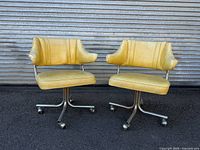 Both yellow vinyl swivel chairs front view