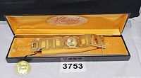 Watch laid out inside open presentation box showing entire bracelet and dial