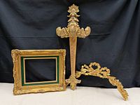 All three gilded pieces together against black backdrop