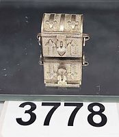 Front view of silver-plated miniature chest charm