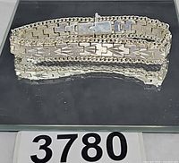 Full view of silver-tone bracelet with lot number