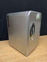 Left-front view of silver mini fridge cooler warmer