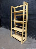 Front angled view of entire light wood bookcase