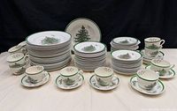 Full grouping of Spode Christmas Tree dinnerware showing plates, cups and saucers