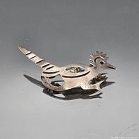 Front view of sterling silver bird brooch showing design and shell inlay