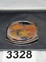 Front view of sterling brooch showing multicolor cabochon