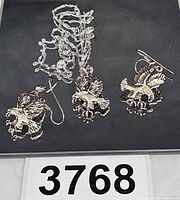 Full set showing chain, pendant and earrings