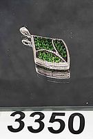 Front view of pendant showing leaf design and green CZ