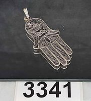 Front view of sterling silver filigree Hamsa pendant showing overall design